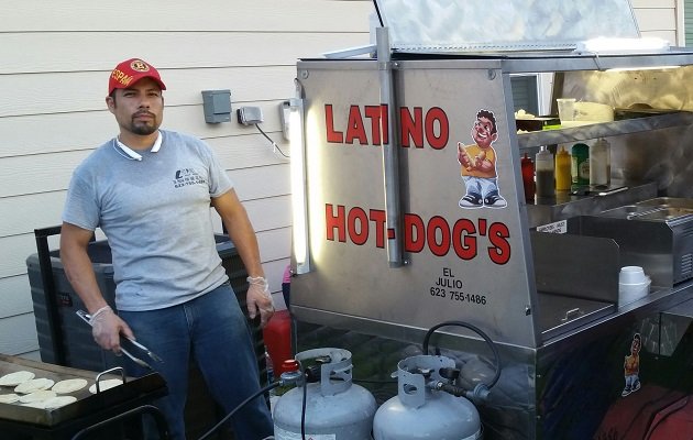 Julio Mireles by one of his food carts.